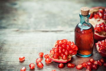 website image pomegranate and glass bottle