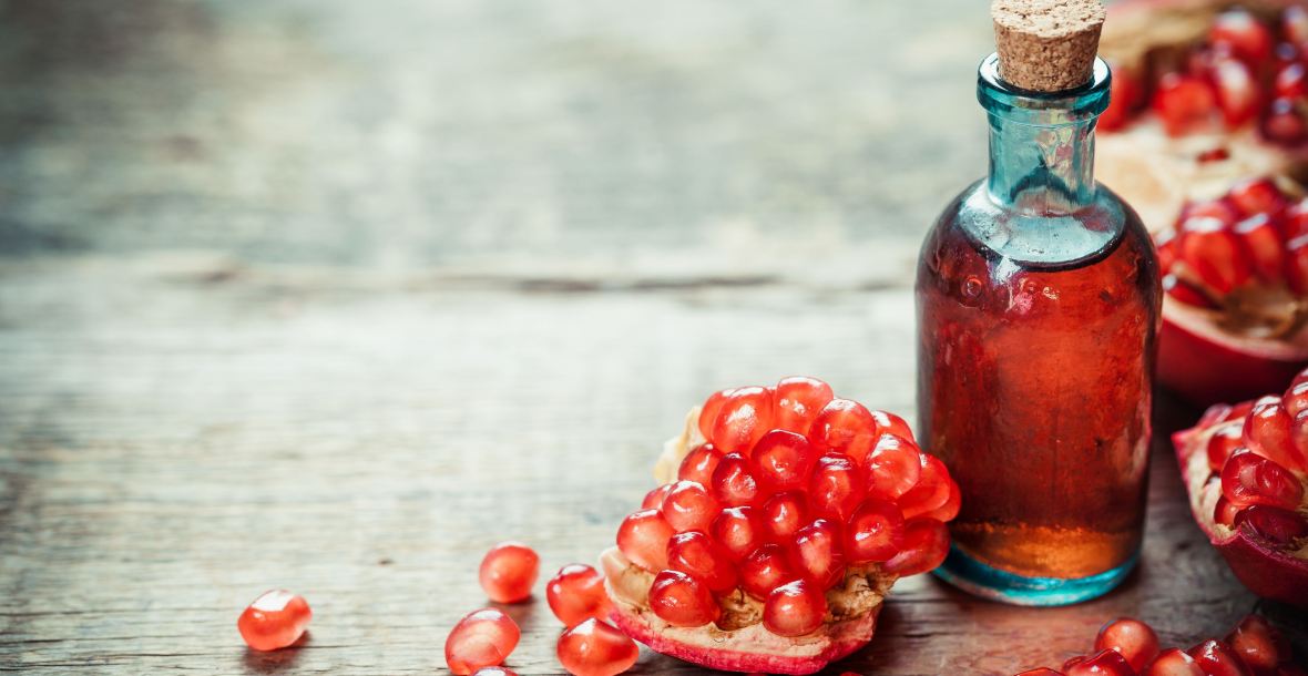 website image pomegranate and glass bottle